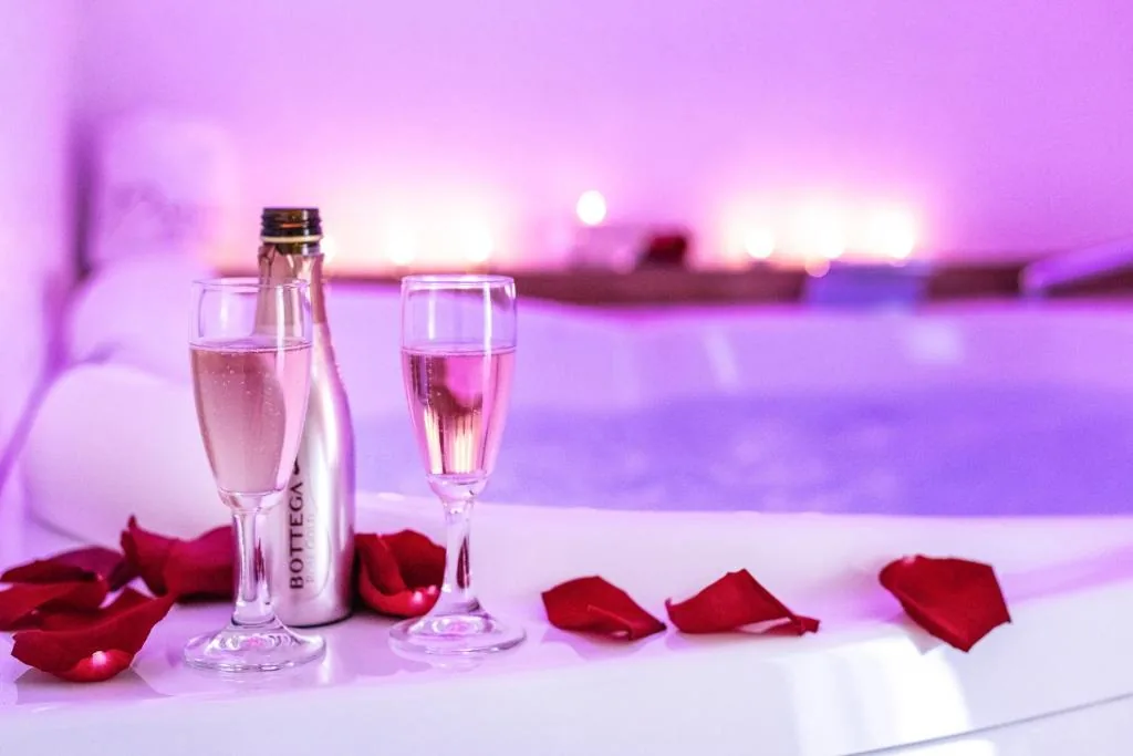 Two glasses of sparkling rosé beside the whirlpool